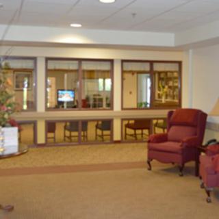 A cozy waiting area with an armchair and large windows.