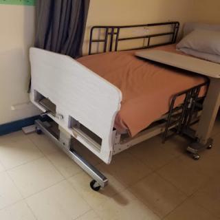 A hospital bed prepared for patient use.