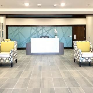 A modern office lobby with stylish seating and a reception desk.