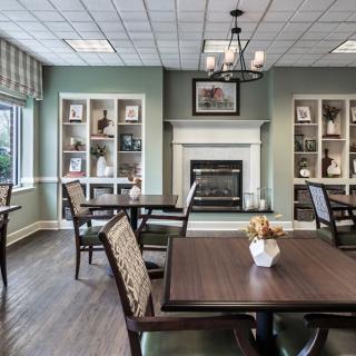 A cozy dining room with elegant decor and a fireplace.