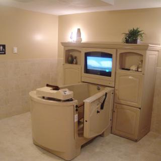 A cozy bathroom space featuring an entertainment unit with a television, perfect for relaxation.