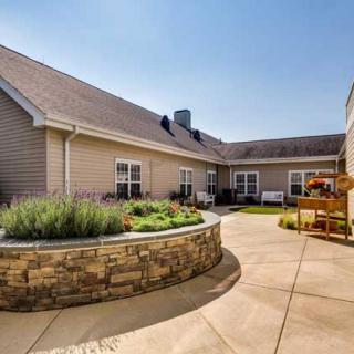 A well-maintained courtyard with a garden and patio area adjacent to a building.