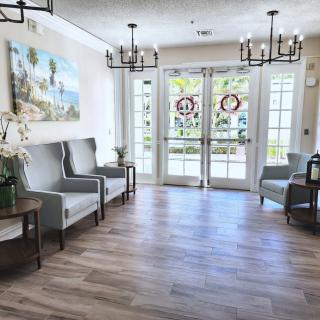 A modern lobby with comfortable chairs and decorative lighting.
