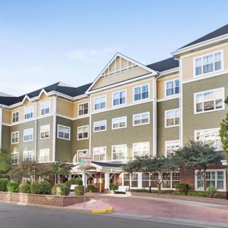 A multi-story residential building with a welcoming entrance.