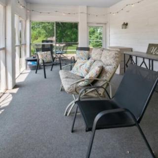 A spacious sunroom with comfortable seating and ample natural light.
