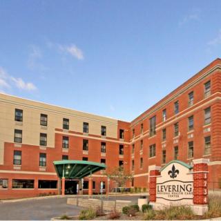 A modern hotel building with a brick exterior and welcoming entrance.