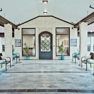 A spacious and modern lobby with a welcoming entrance, featuring comfortable seating and ample natural light.