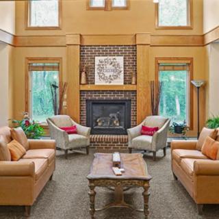 A cozy living room with a fireplace and comfortable seating.