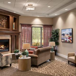 A cozy living room with a fireplace, comfortable sofas, and elegant decor.