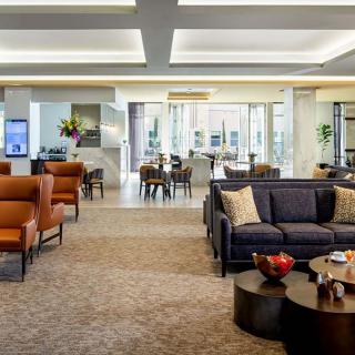 A spacious and modern lobby featuring comfortable seating areas with elegant furnishings.