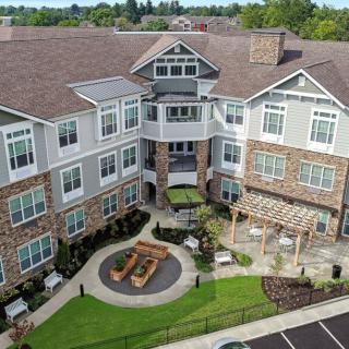 Aerial view of a modern residential building with a landscaped courtyard.