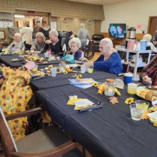 A group of seniors enjoying a meal together at a community gathering.