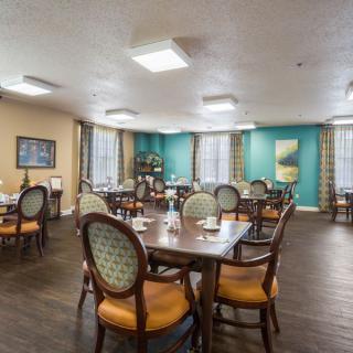 A well-decorated dining area with neatly arranged tables and chairs.
