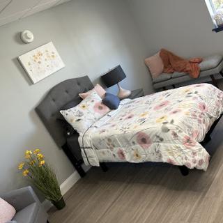 A beautifully styled bedroom featuring floral bedding and a cozy atmosphere.