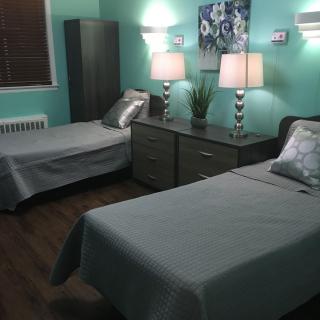 A cozy bedroom with two twin beds and stylish decor.