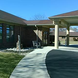 A well-maintained building with a landscaped entrance on a sunny day.