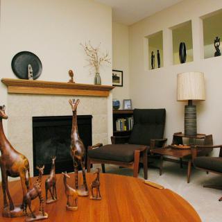 A cozy living room with modern decor, featuring a fireplace and stylish furniture.
