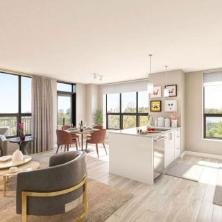 A modern open-concept living room and kitchen with large windows and stylish decor.