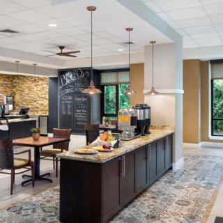 A modern cafe interior with a coffee station and seating area.