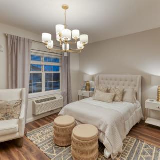 A modern, cozy bedroom with elegant lighting and decor.