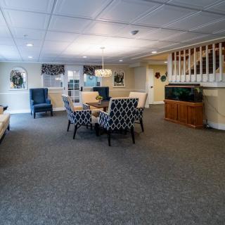 A cozy living room with a central seating area and decorative elements.