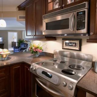 A modern kitchen with stainless steel appliances and dark wood cabinets.