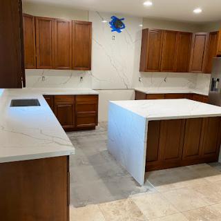 A modern kitchen featuring wooden cabinets and a spacious island.