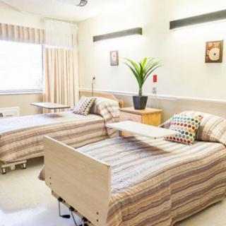 A clean and well-organized hospital room with two beds.