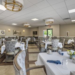 Elegant dining room with neatly arranged tables and chairs.
