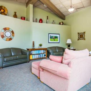 A cozy living room with comfortable seating and decorative elements.