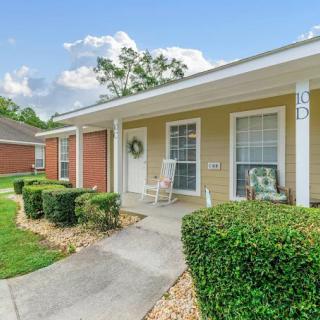 A cozy house with a porch and well-maintained landscaping.