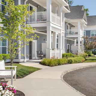 A modern residential apartment building with well-maintained landscaping.