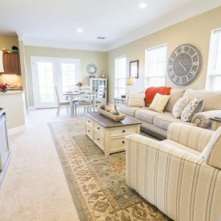 A bright and cozy living room with an open floor plan, featuring a comfortable sofa, coffee table, and tasteful decor.
