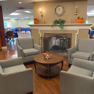 A cozy lounge area featuring comfortable seating, a coffee table, and a fireplace.