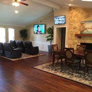 A cozy living room with comfortable seating, a television, and a fireplace.