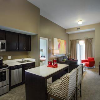 A modern open-concept kitchen and living room with an island counter and stylish furniture.