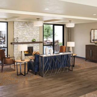 A modern living room with a cozy seating area and a fireplace.