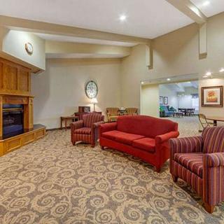 A cozy lobby with red and striped seating, decorative carpet, and a warm ambiance.