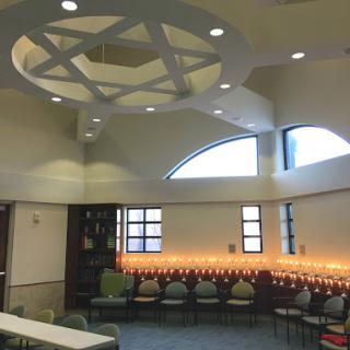 Interior view of a modern synagogue, featuring elegant architectural design and warm lighting.