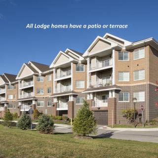 A row of modern apartment buildings with patios and terraces.