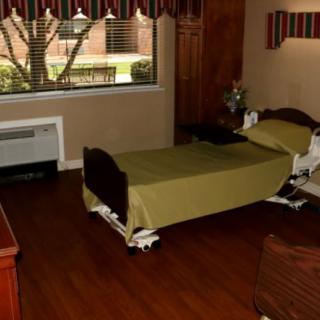 A room with a single hospital bed and a window.