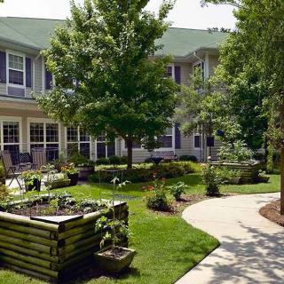 A tranquil courtyard with lush greenery and a well-maintained garden.