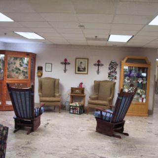 A cozy waiting area featuring rocking chairs and decorative elements.