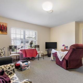 A cozy living room with seating area and a television.