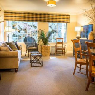 A cozy, well-lit living room with comfortable seating and tasteful decor.
