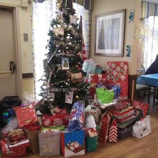 A beautifully decorated Christmas tree surrounded by colorful presents, creating a cheerful holiday atmosphere.