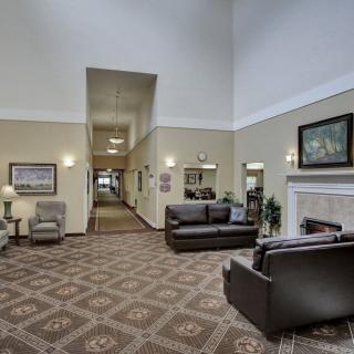 A spacious and elegantly decorated lobby with comfortable seating and a fireplace.