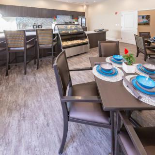 A modern dining area with a neatly set table and elegant interior design.