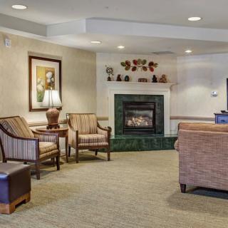 A cozy living room featuring comfortable seating and a fireplace.
