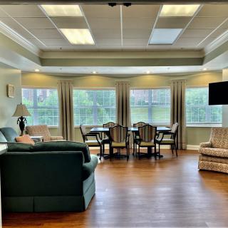 A spacious living room with comfortable seating and large windows.